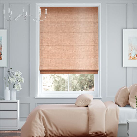 A bedroom featuring a bed with beige bedding, a dresser topped with a vase of flowers, and two framed artworks gracing the walls. The window is adorned with an elegant beige Roman blind that complements the tranquil ambiance perfectly.