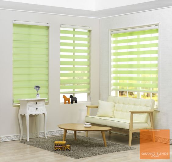 The room features light green Zebra Blind Range B, a white cushioned bench, and a wooden coffee table on a gray rug. A small white side table adds charm, while two miniature horse figures grace the windowsill.