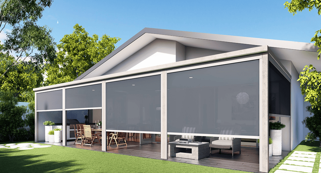 Modern house with a covered patio featuring outdoor dining and seating, complemented by Outdoor Straight Drop Blinds for shade. A lush lawn and clear sky complete the ideal setting for comfortable outdoor living.