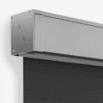 Close-up of the Outdoor Straight Drop Blind's metallic housing with a partially unrolled black screen extending downward, showcasing its modern and functional design.