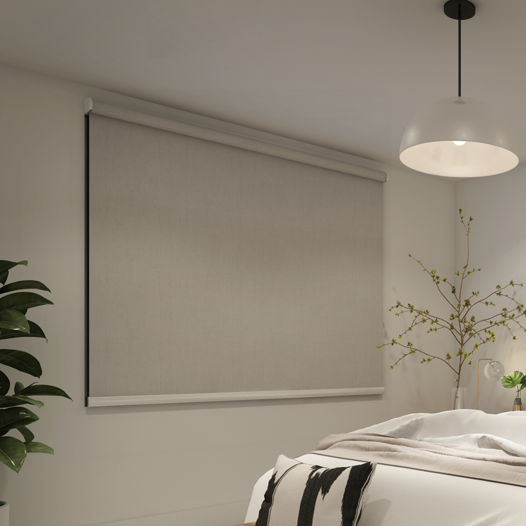 A modern bedroom is styled with Premium Range Roller Blinds, a white pendant light, a leafy potted plant, and minimal decor on the side table.