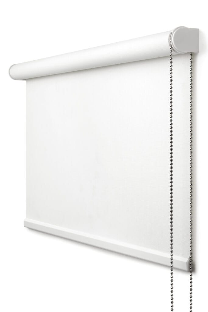 A white roller blind with a beaded pull chain is mounted on a wall, partially unrolled.
