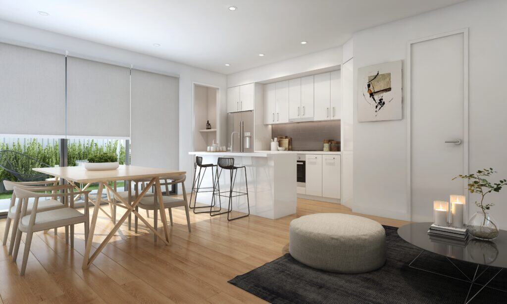 Modern kitchen and dining area with white cabinets, a wooden dining table, and barstools. Features a pouf, candles, and an abstract painting. Natural light from large windows with blinds.