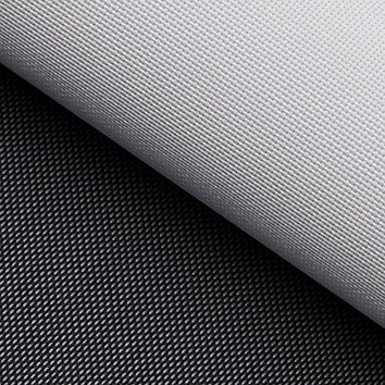 Close-up of a textured, rolled white fabric sheet placed diagonally over a similar black fabric, both showing a fine, grid-like pattern.