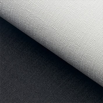 A close-up of a textured sheet of white paper overlapping a similarly textured dark gray surface.