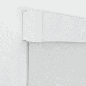 Close-up of a white roller blind mounted on a wall, showing the top casing and a section of the fabric.