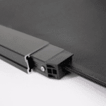 Close-up of a black metal and plastic frame with a fabric material attached, showing a corner join secured with a visible screw.