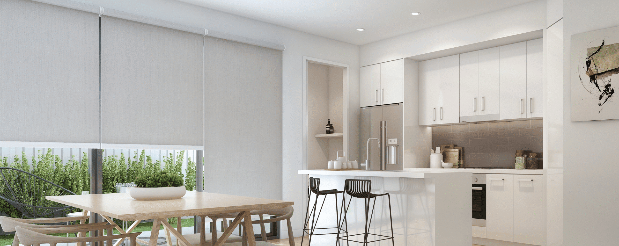 Modern kitchen and dining area with light-colored cabinetry, a small island with two bar stools, a wooden dining table, and large windows with roller blinds.